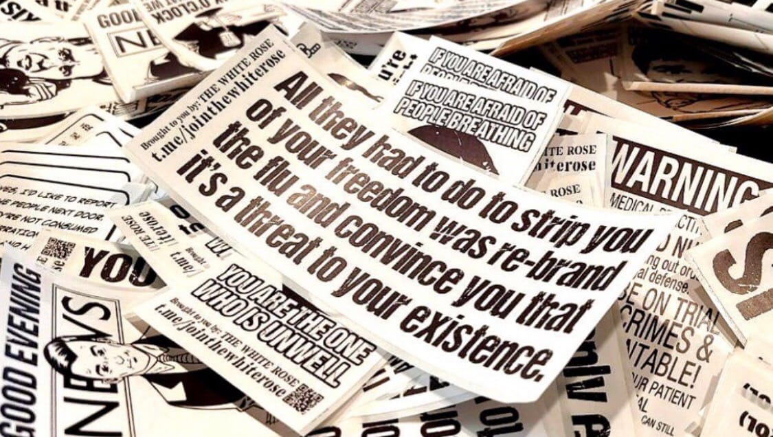 A pile of stickers with disinformation on them.